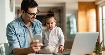 Father working from home with child